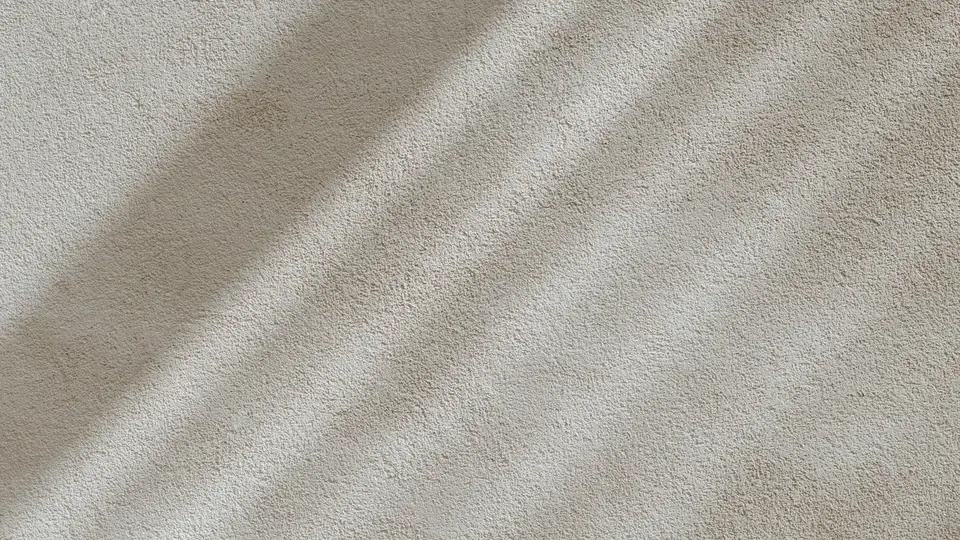 Luz e sombra sobre uma superfície clara e texturizada